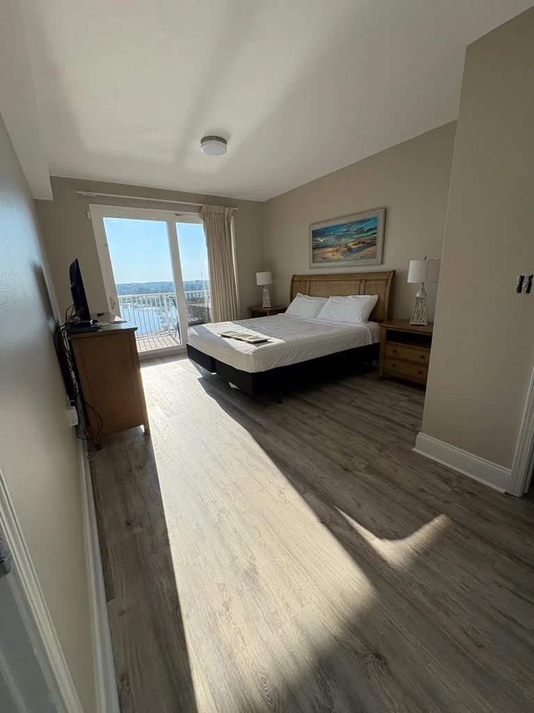 Master bedroom after repainting in a warm coastal greige tone